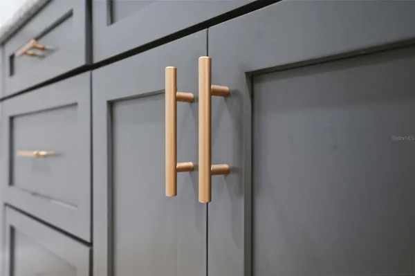 a large kitchen with granite countertop a large counter top appliances and cabinets