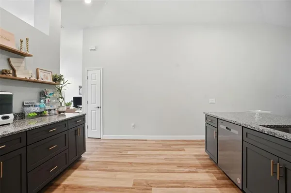 a dining room with furniture a chandelier and wooden floor