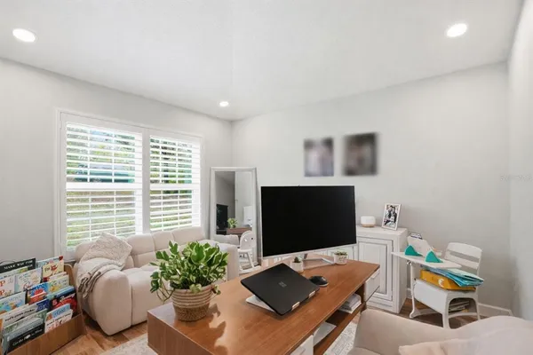 a room with lots of wooden furniture and glass door