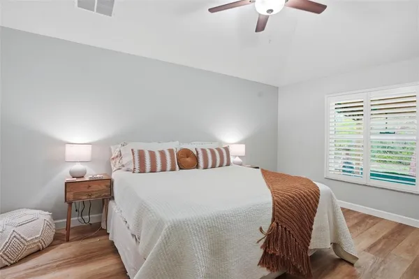 a living room with a couch and a potted plant
