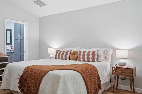 a bedroom with a bed and a chandelier