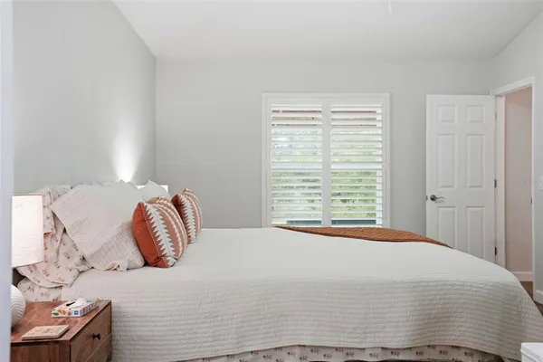 a bathroom with a granite countertop double vanity sink and a mirror
