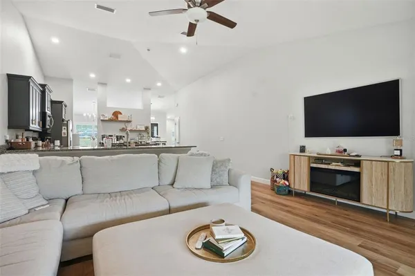 a living room with furniture and wooden floor