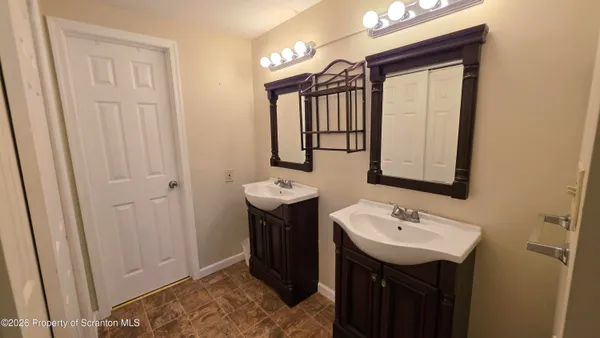 a bathroom with a sink vanity and a mirror