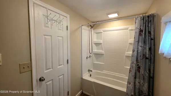 a bathroom with a shower and a tub