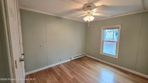 wooden floor in an empty room with a window