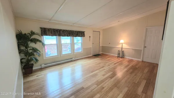 wooden floor in an empty room with a window