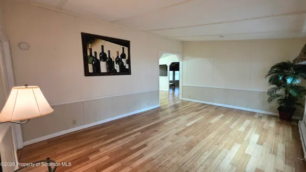 a view of a room with wooden floor and bench