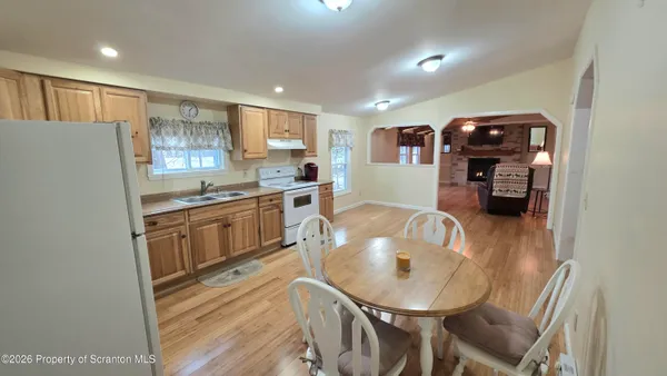 a kitchen with stainless steel appliances granite countertop a sink refrigerator and cabinets