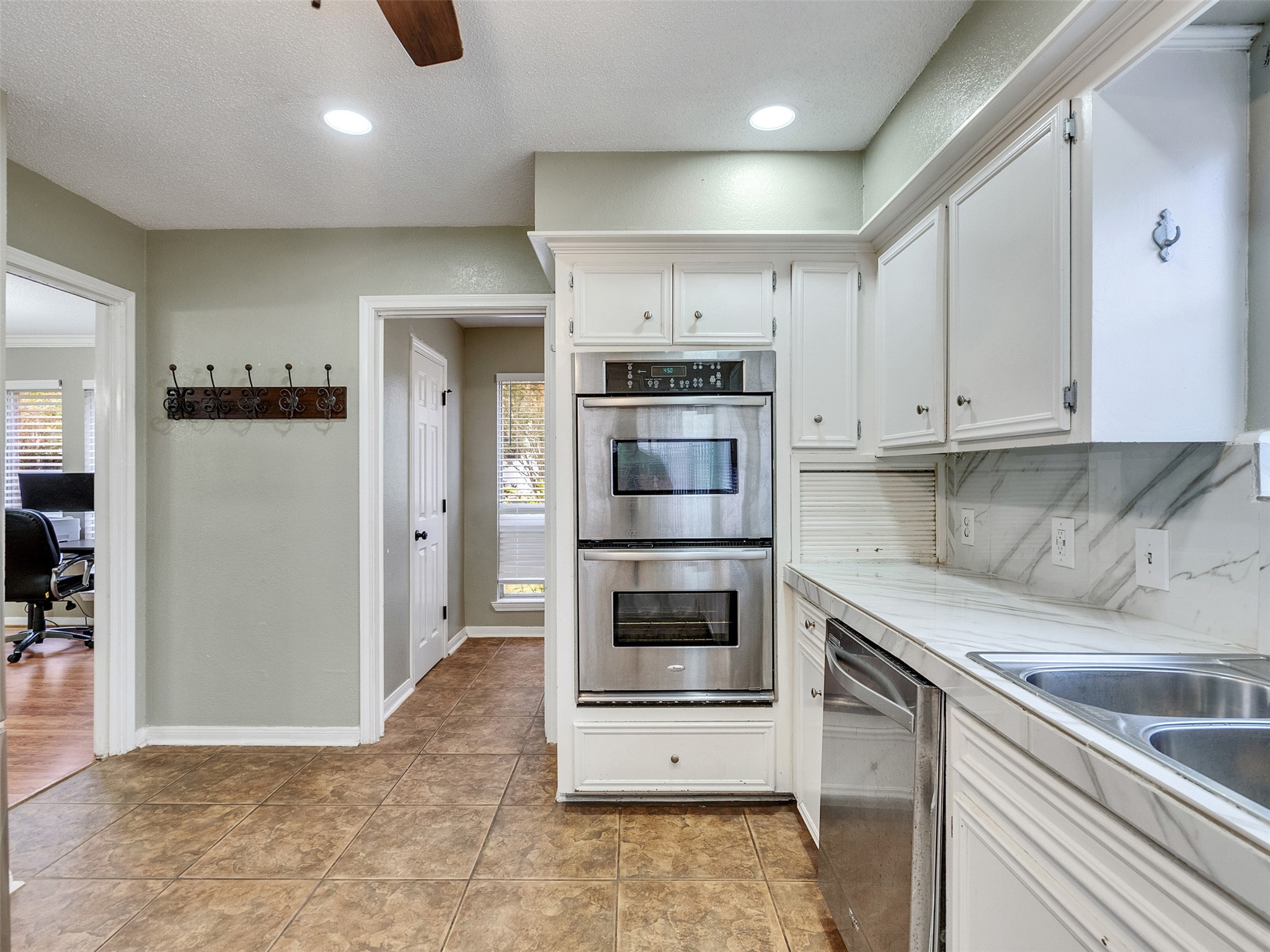 15703 Crestbrook Drive Houston, TX 77059 - Photo 16 of 50 Double Oven and laundry located at the end of kitchen with 1/2 bath