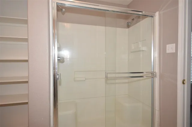 a bathroom with a glass shower door
