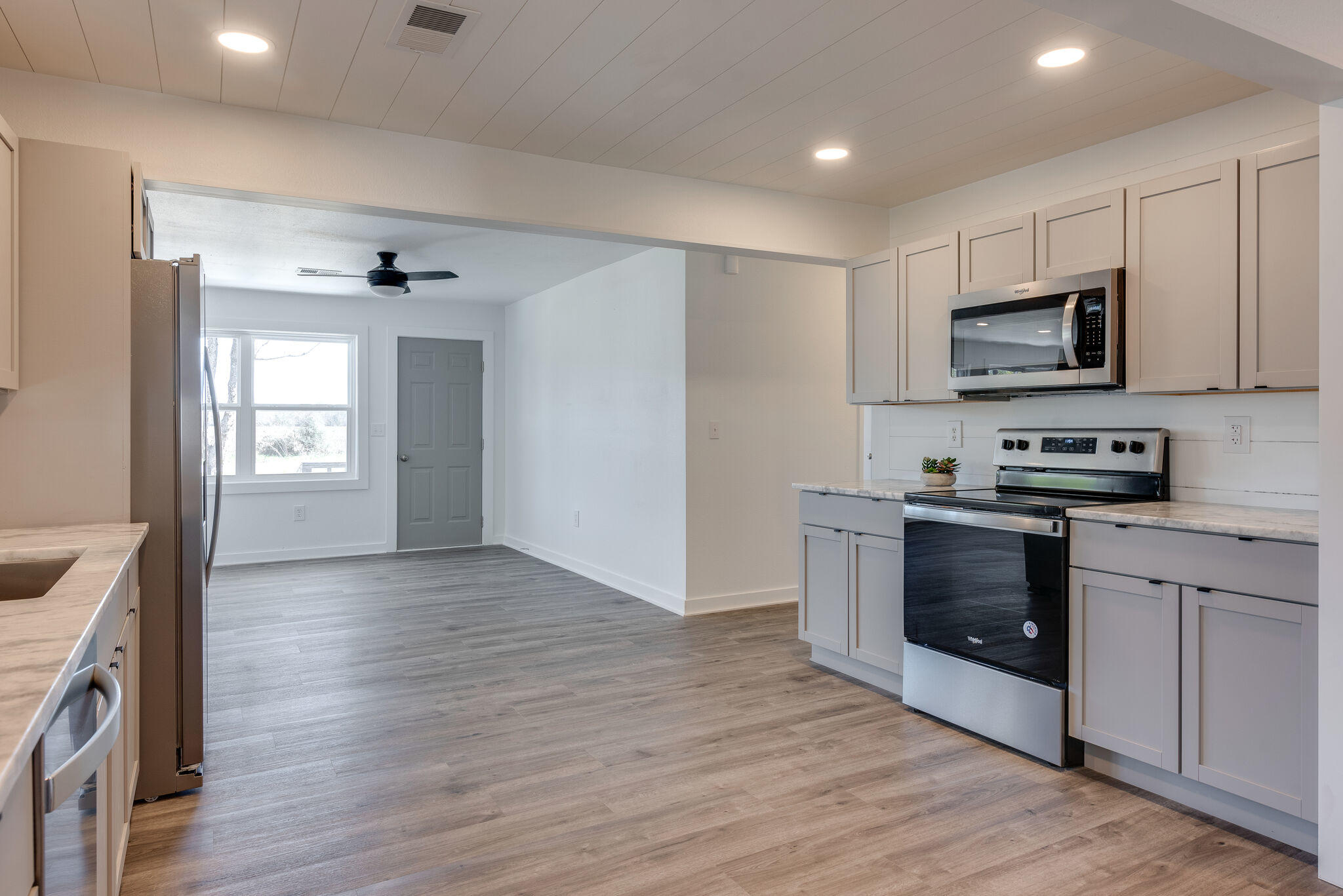 5238 Griffith Mill Road Baker, FL 32531 - Photo 14 of 34 a kitchen with stainless steel appliances granite countertop a stove a sink and a refrigerator