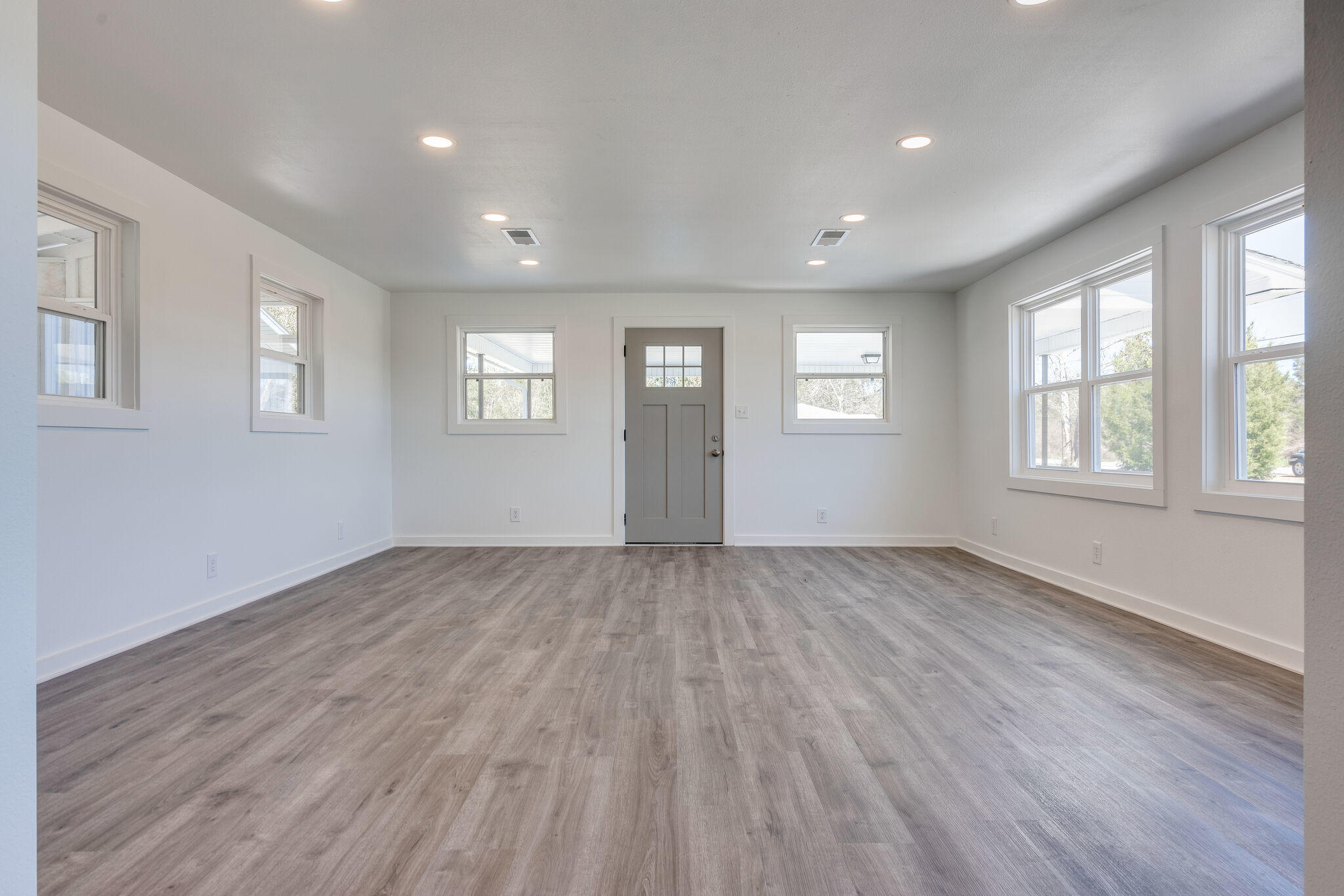5238 Griffith Mill Road Baker, FL 32531 - Photo 10 of 34 a view of an empty room with wooden floor and window