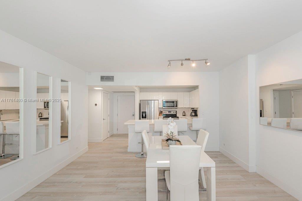 2301 Collins Avenue, Unit 401 Miami Beach, FL 33139 - Photo 15 of 38 a view of a dining room with furniture