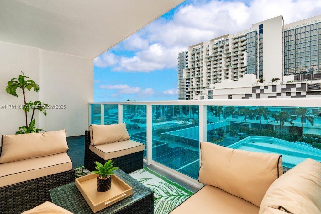 2301 Collins Avenue, Unit 401 Miami Beach, FL 33139 - Photo 2 of 38 a view of a patio with couches chairs and a fire pit