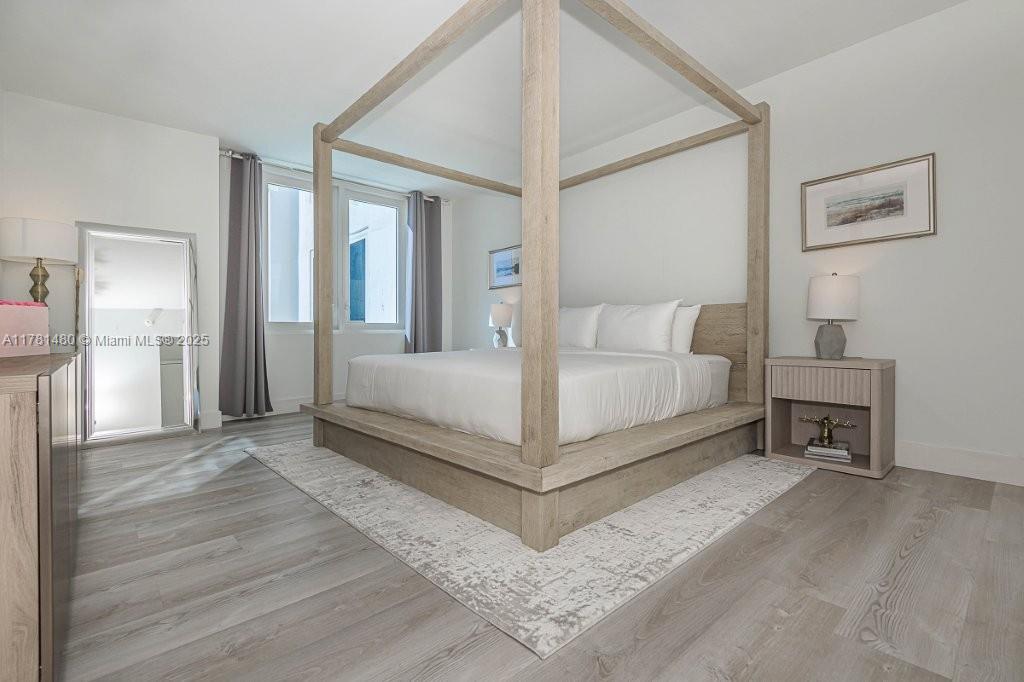 2301 Collins Avenue, Unit 401 Miami Beach, FL 33139 - Photo 23 of 38 a living room with a bed and a table