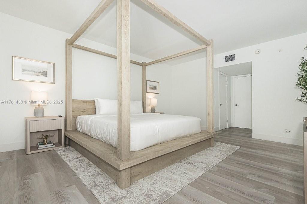 2301 Collins Avenue, Unit 401 Miami Beach, FL 33139 - Photo 24 of 38 a bedroom with a bed and a table