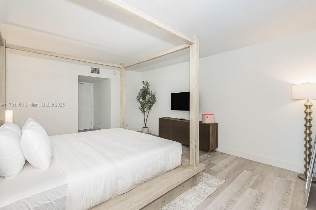 2301 Collins Avenue, Unit 401 Miami Beach, FL 33139 - Photo 25 of 38 a bedroom with a bed and a flat screen tv