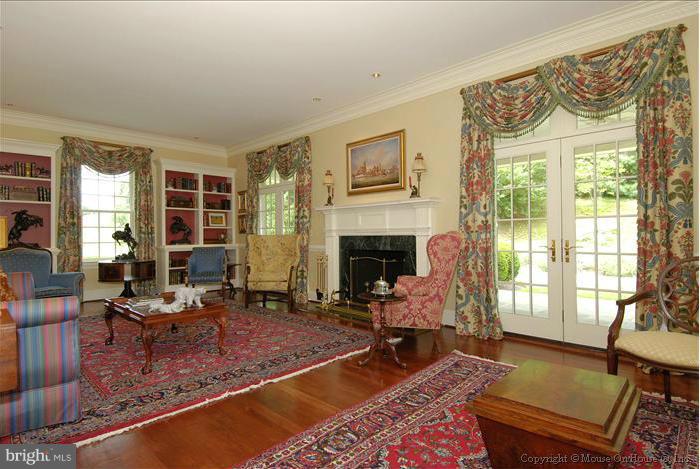 2121 Gadd Road Cockeysville, MD 21030 - Photo 7 of 28 a living room with furniture a fireplace and a floor to ceiling window