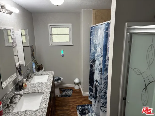 a bathroom with a sink toilet and shower