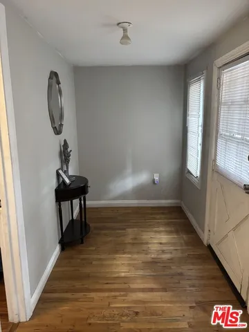 a view of a livingroom with wooden floor and a staircase