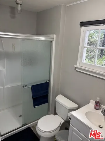 a white toilet sitting next to a bathroom sink