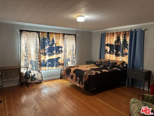 a bedroom with a bed and a large window