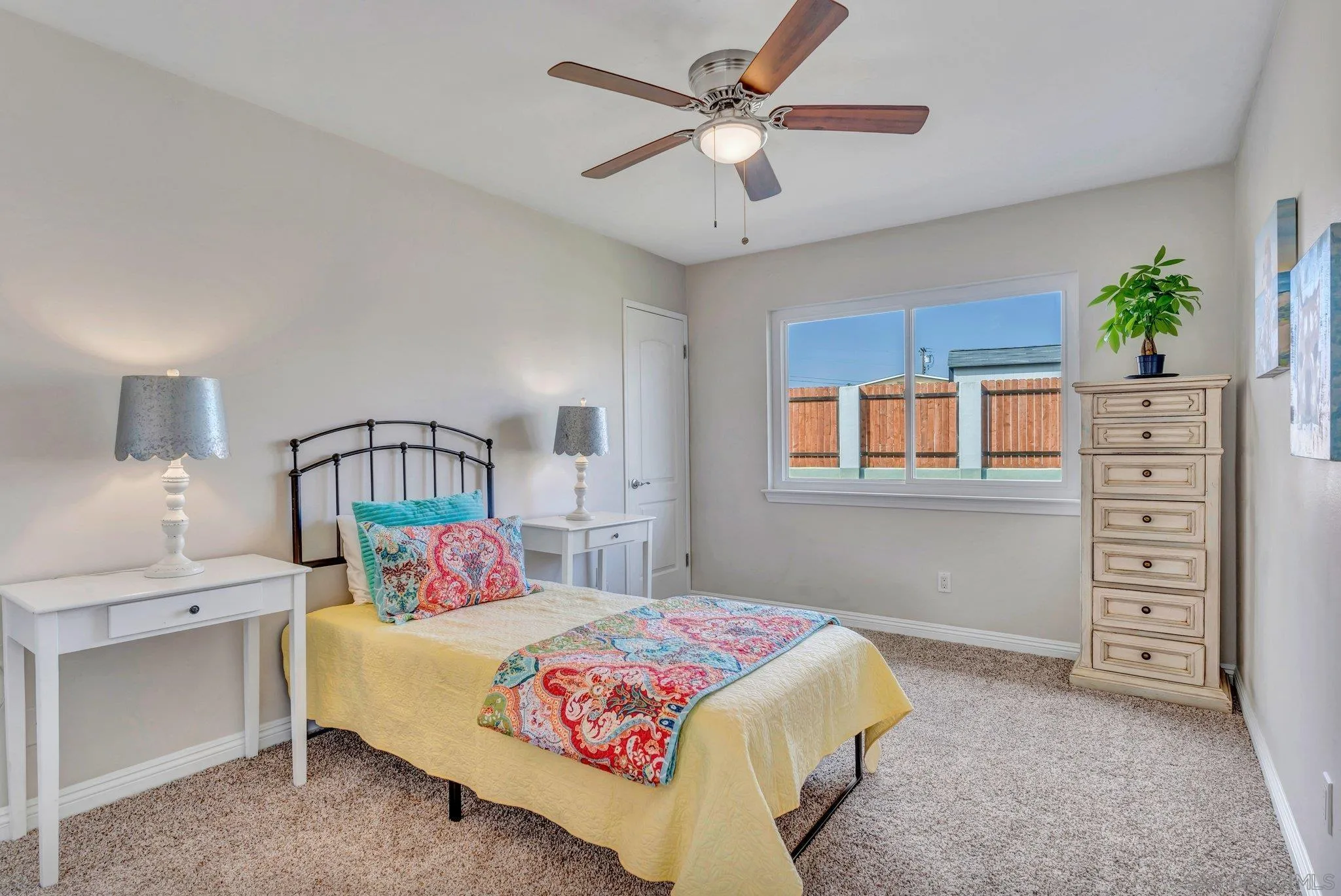 1217 Memory Lane Vista, CA 92084 - Photo 16 of 72 a bedroom with a bed and a chandelier