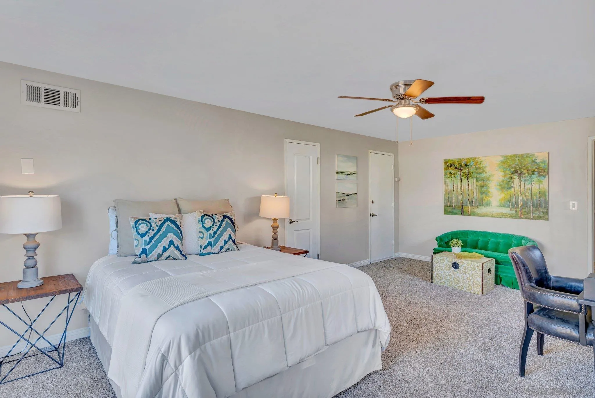 1217 Memory Lane Vista, CA 92084 - Photo 22 of 72 a bedroom with a bed a chandelier and a painting on the wall