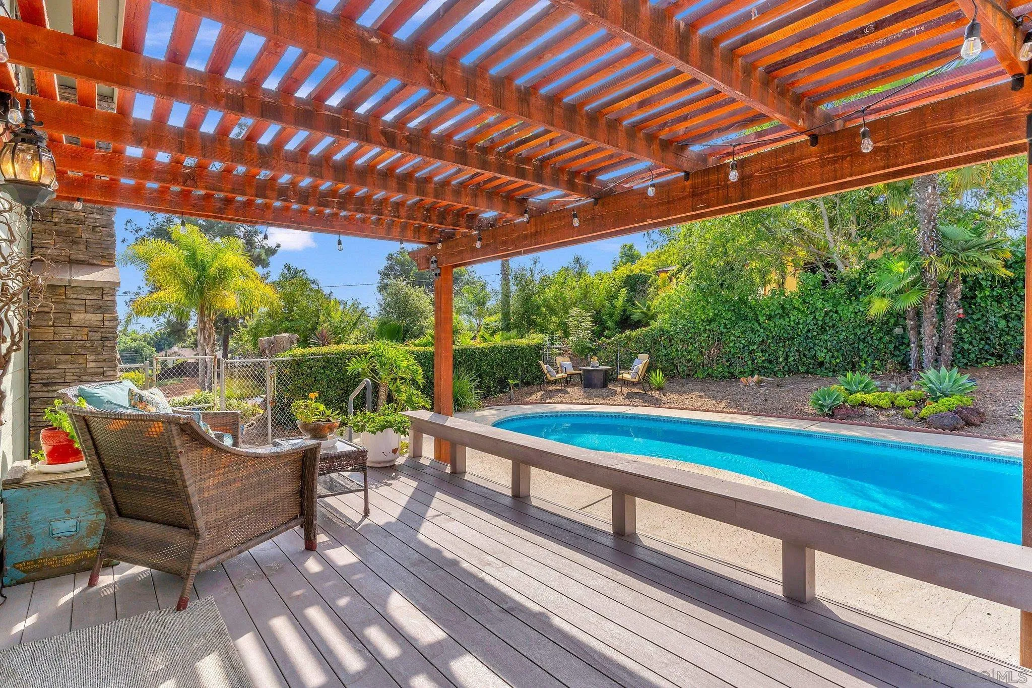 1217 Memory Lane Vista, CA 92084 - Photo 25 of 72 a view of a patio with table and chairs with wooden floor and roof with a garden view