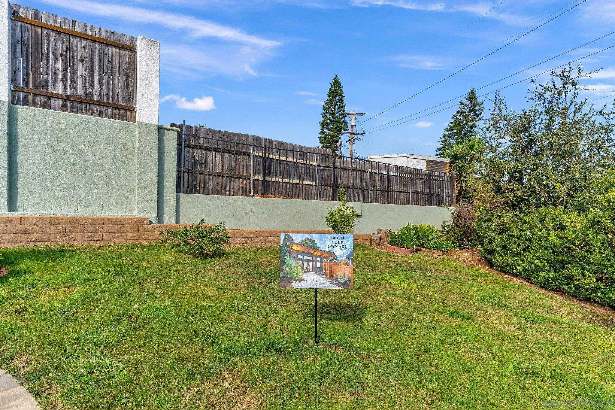 1217 Memory Lane Vista, CA 92084 - Photo 34 of 72 a garden with a bench in front of the house