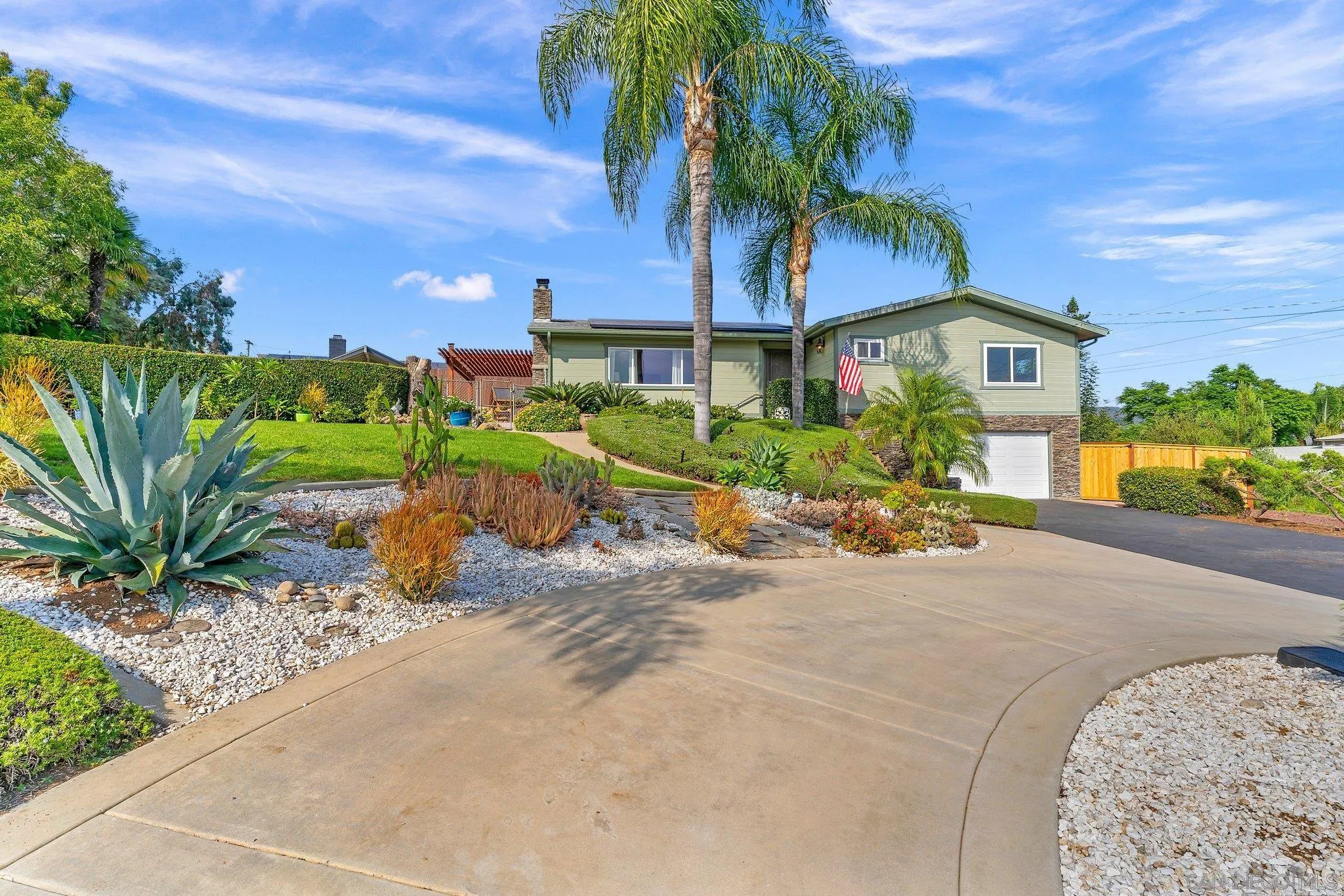 1217 Memory Lane Vista, CA 92084 - Photo 53 of 72 a front view of a house with a garden and mountain view
