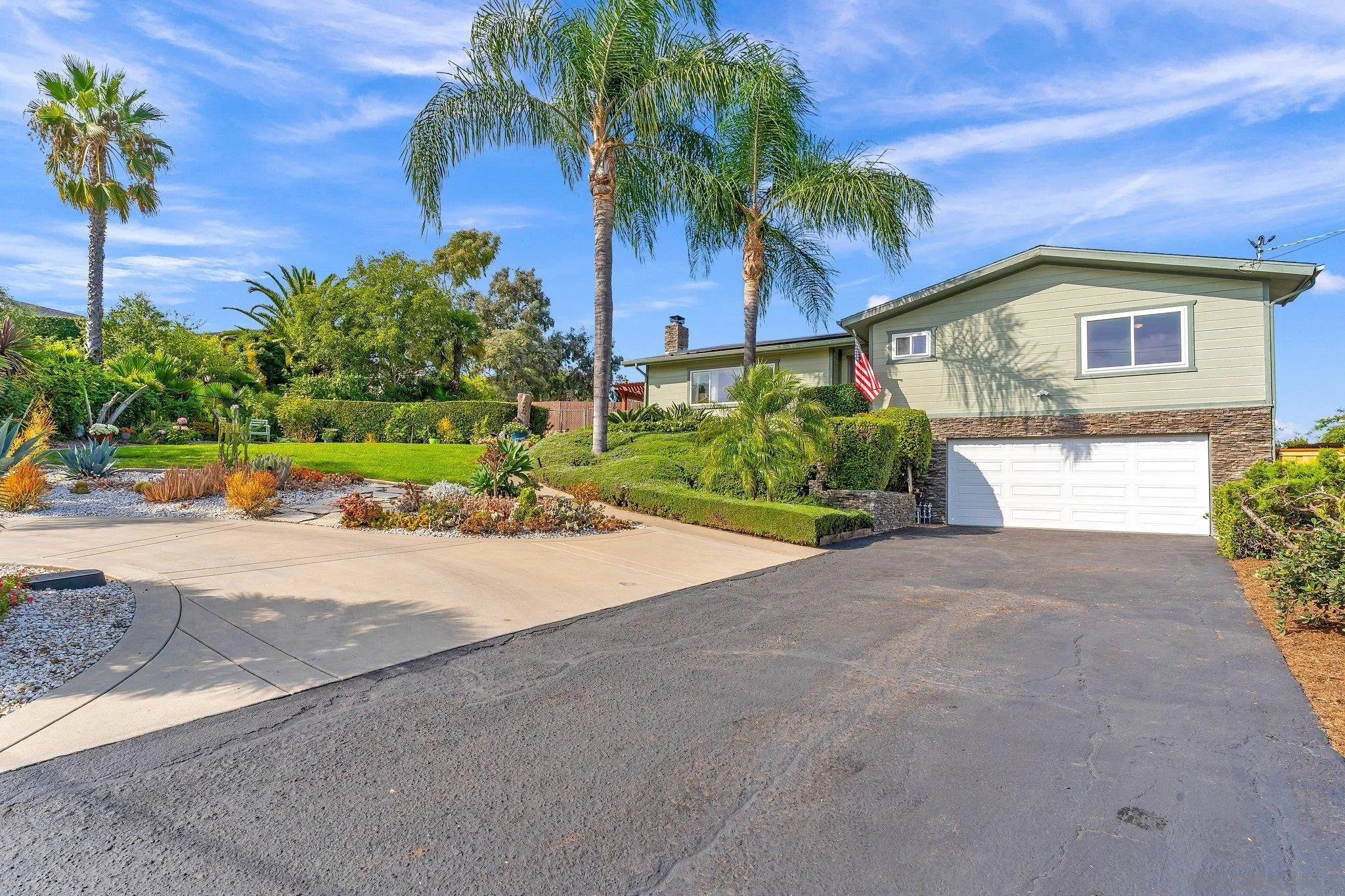 1217 Memory Lane Vista, CA 92084 - Photo 54 of 72 a front view of a house with a yard and a garage