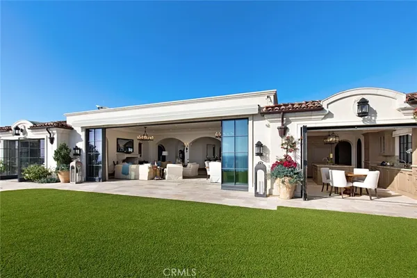 a view of a house with furniture and garden