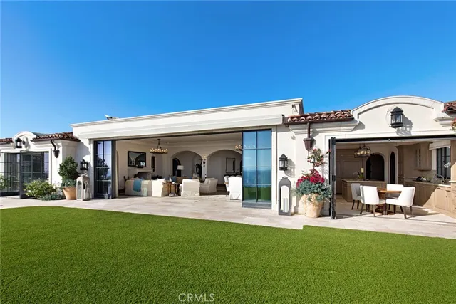 a view of a house with furniture and garden