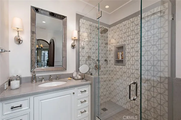 a bathroom with a shower sink and mirror