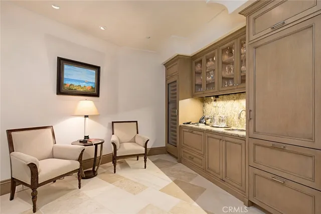 a view of a white house with a yard and potted plants