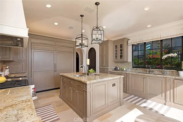 a open kitchen with stainless steel appliances granite countertop a stove and a sink