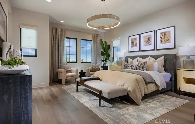 a spacious bedroom with a bed a couch and a potted plant