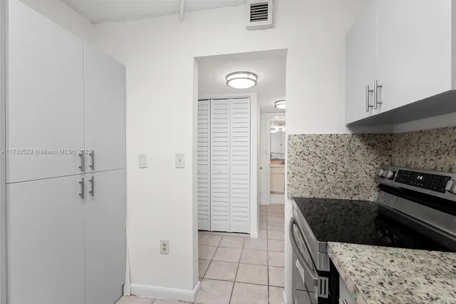 a kitchen with a sink and a stove top oven