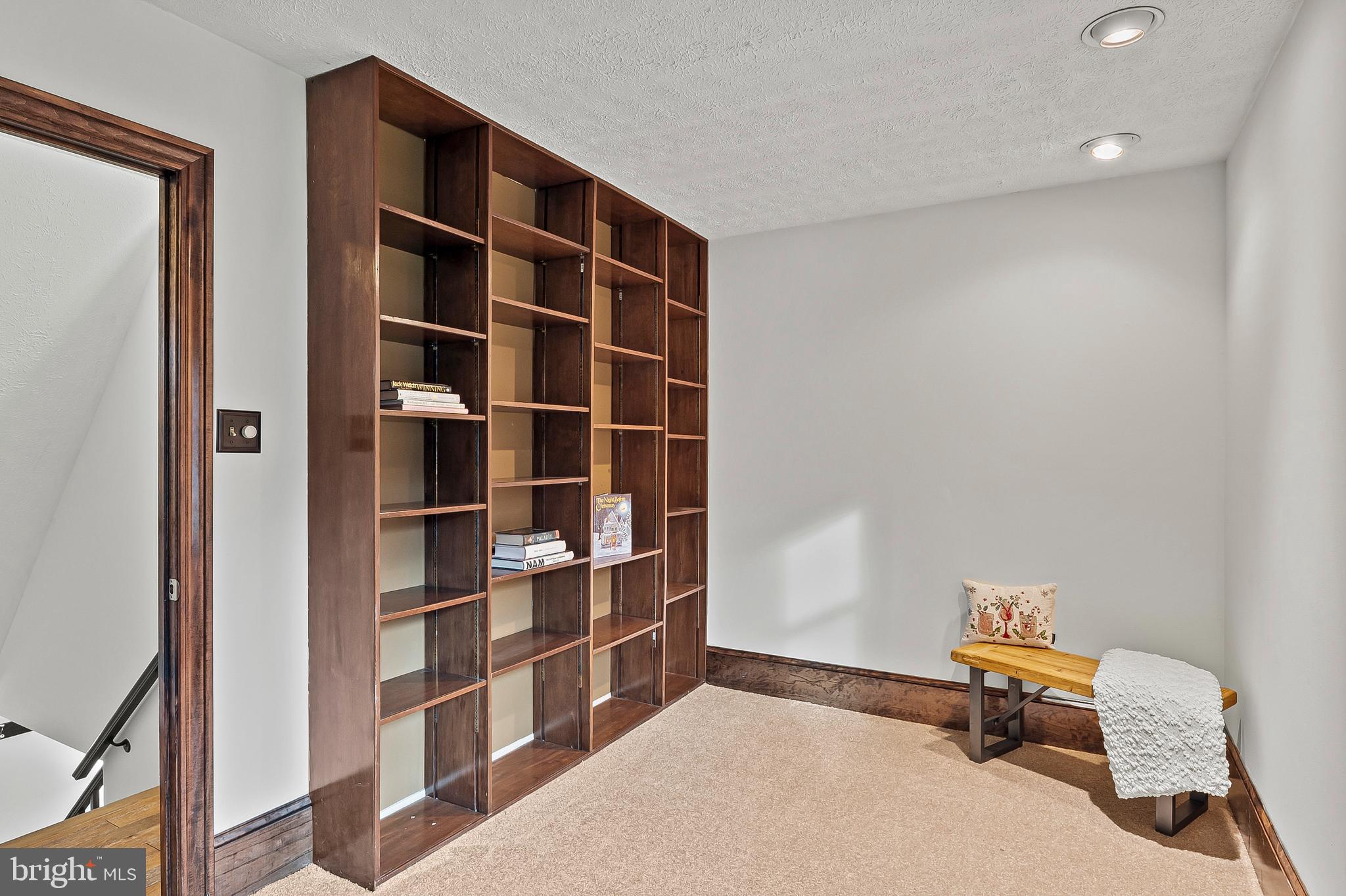 2472 Wintergreen Way Gambrills, MD 21054 - Photo 31 of 55 a room with furniture and a book shelf