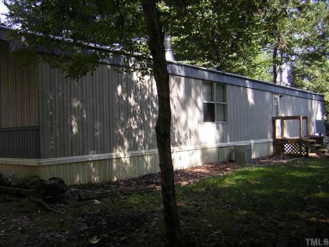 665 Saplin Branch Road Timberlake, NC 27583 - Photo 8 of 10 a backyard of a house with lots of green space and outdoor seating
