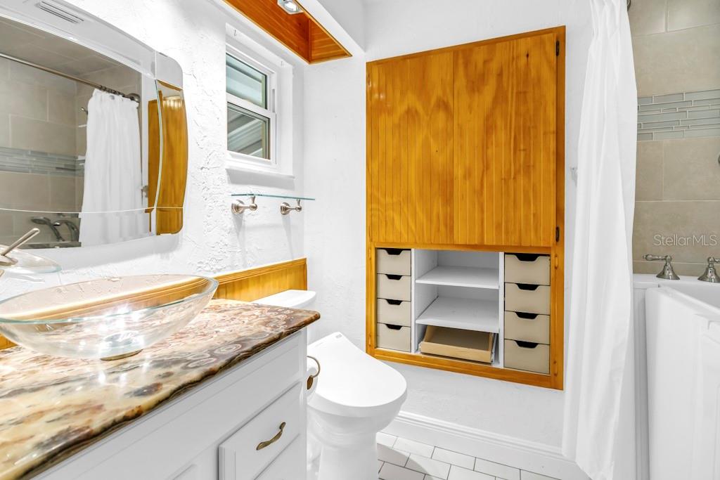 11174 90th Terrace Seminole, FL 33772 - Photo 26 of 35 a bathroom with a granite countertop sink toilet and shower