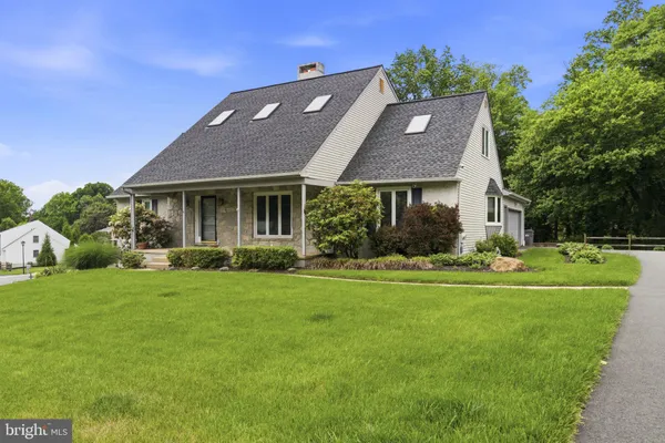 a aerial view of a house with a big yard plants and large trees