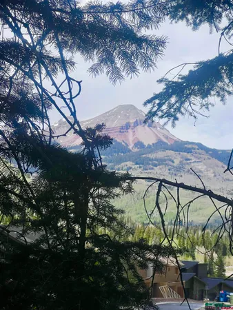 a view of a lake in middle of the mountain