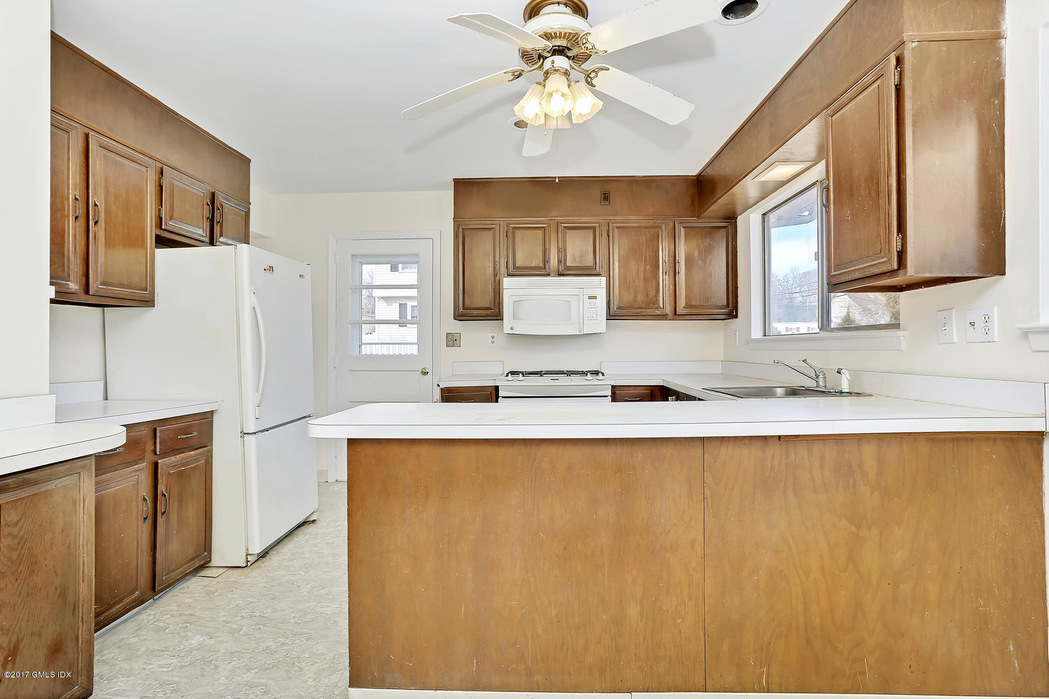 6 Amherst Road Riverside, CT 06878 - Photo 12 of 22 a large kitchen with granite countertop a sink a counter top space and stainless steel appliances