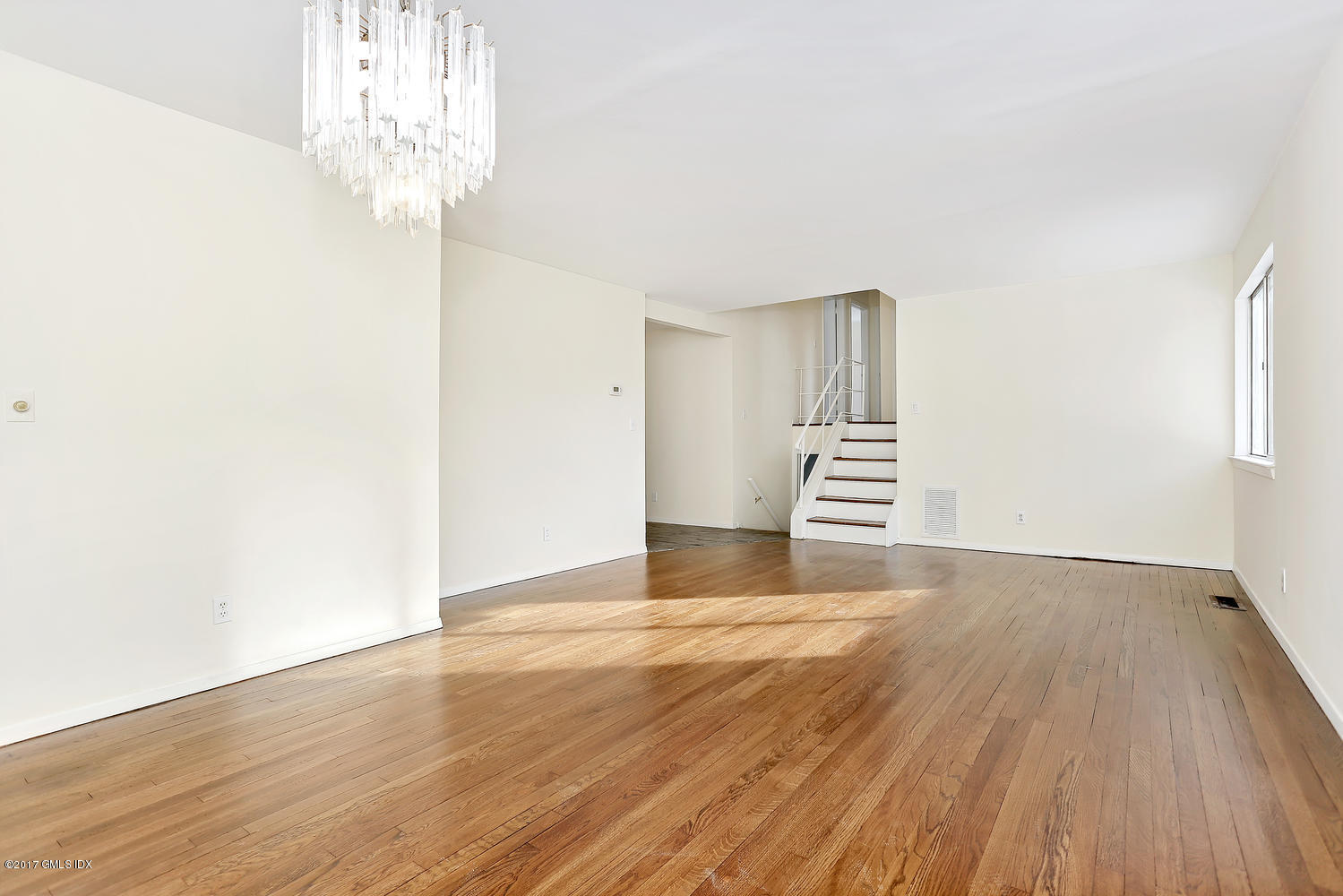 6 Amherst Road Riverside, CT 06878 - Photo 14 of 22 an empty room with wooden floor chandelier and windows