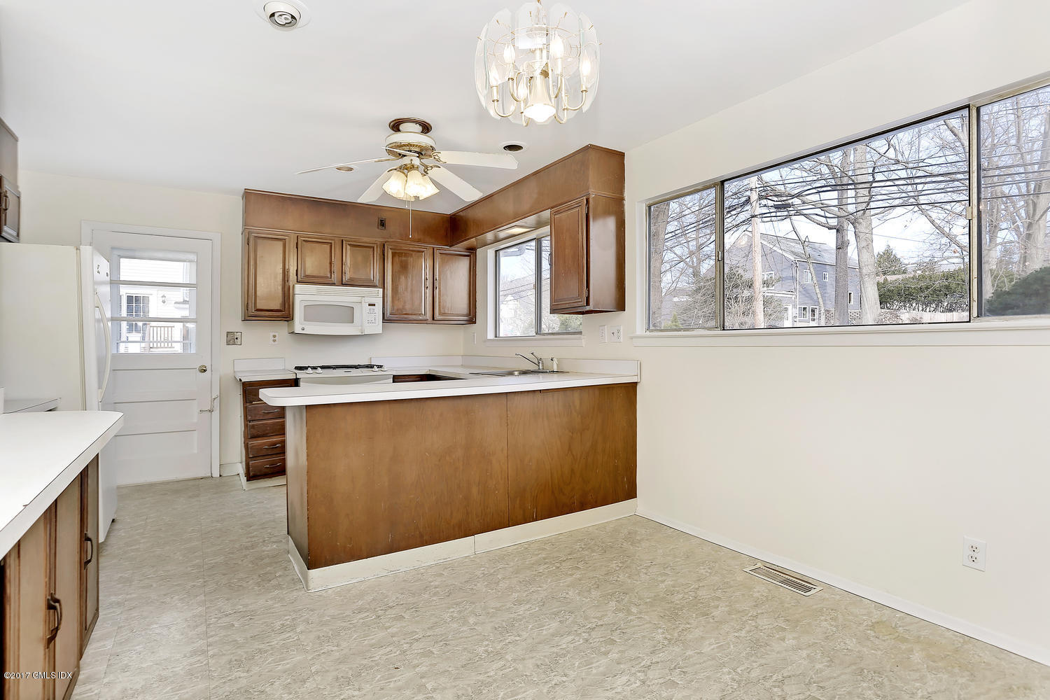 6 Amherst Road Riverside, CT 06878 - Photo 10 of 22 a large kitchen with granite countertop a stove a sink a window and a dining table