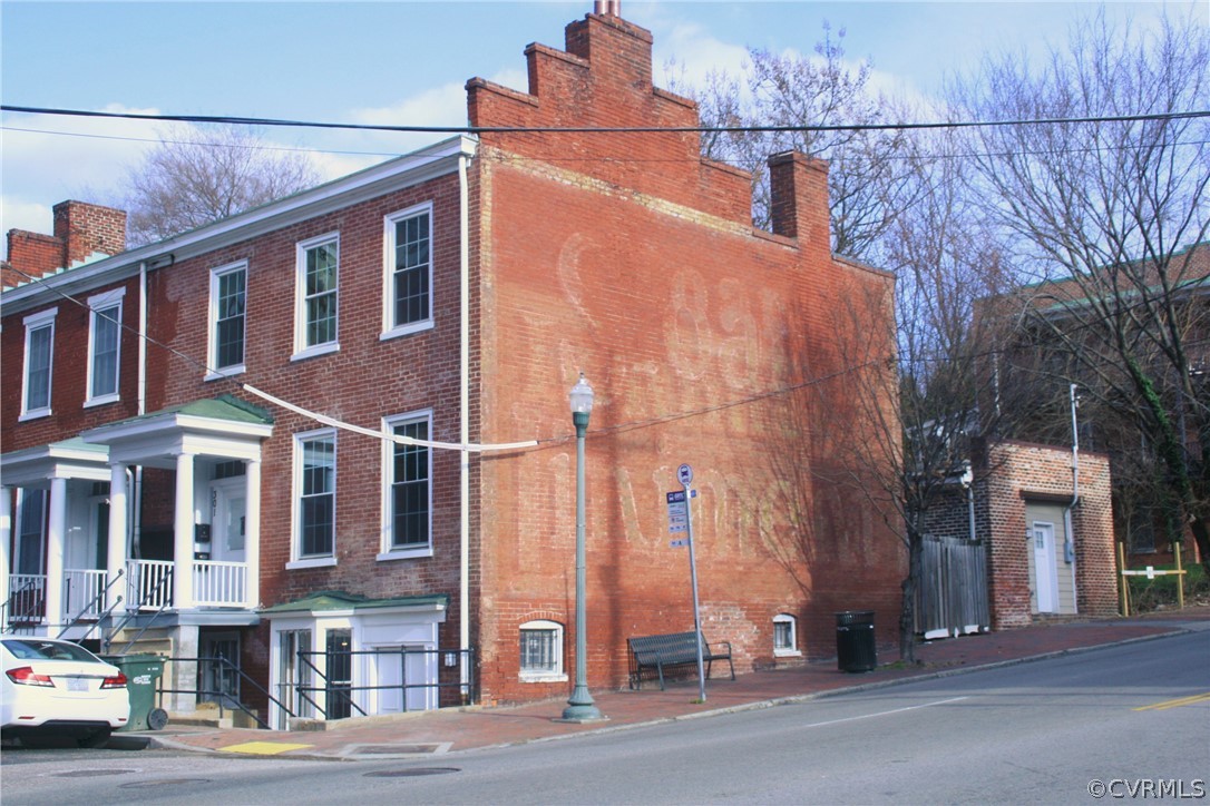 a view of a brick building next to a road