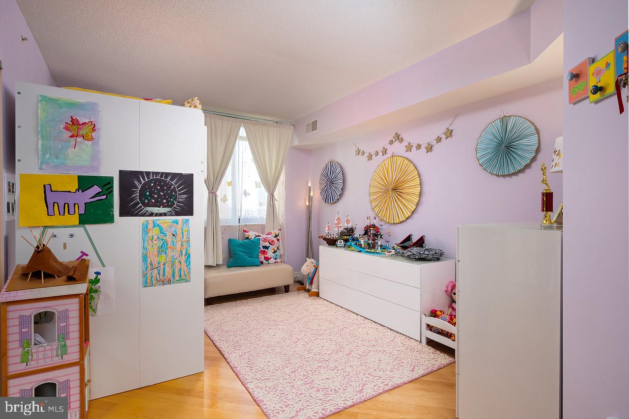 414 Water Street, Unit 1502 Baltimore, MD 21202 - Photo 13 of 32 a room with toys and a wooden floor